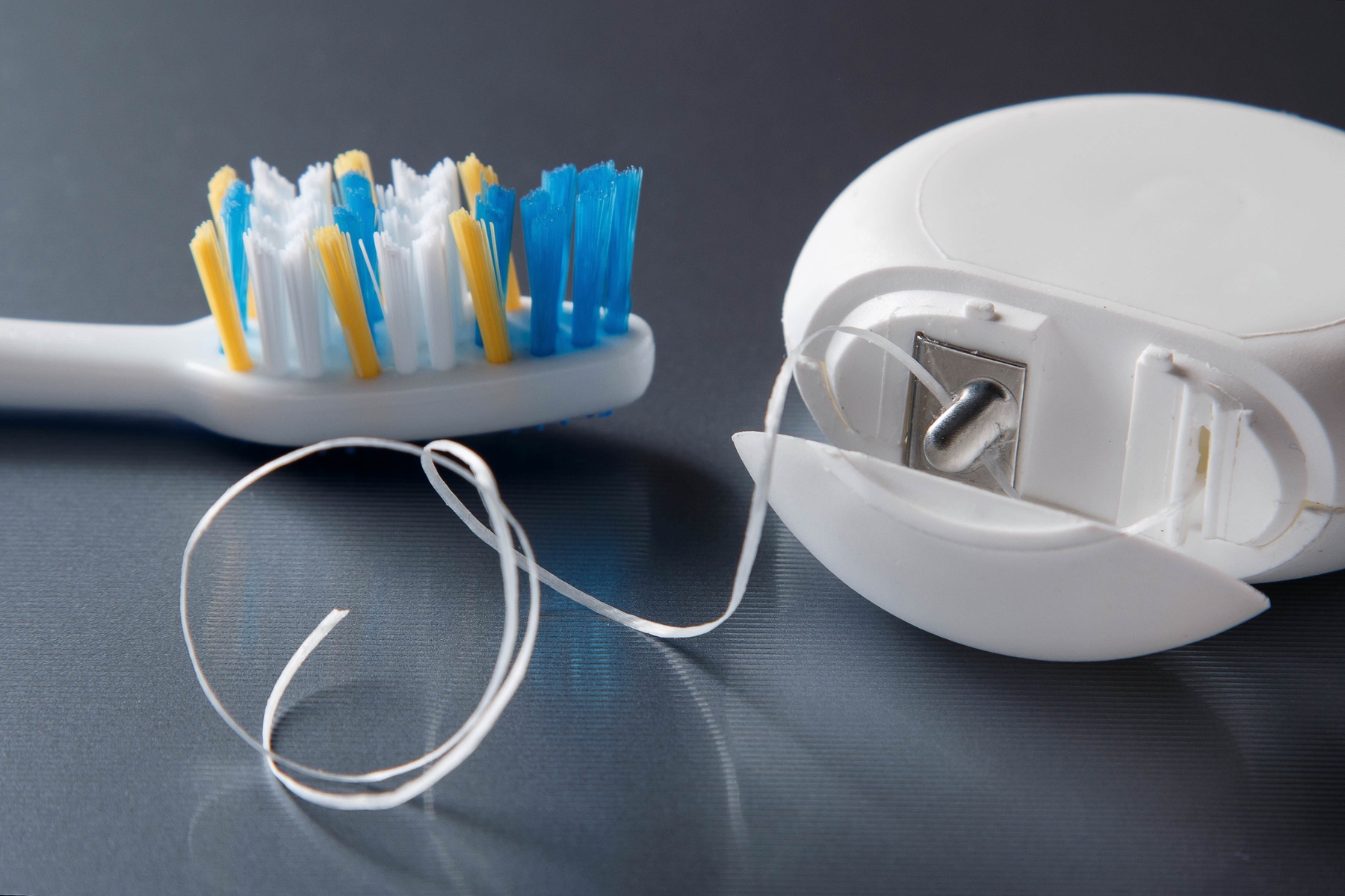 close up of floss and toothbrush | dentist toowoomba