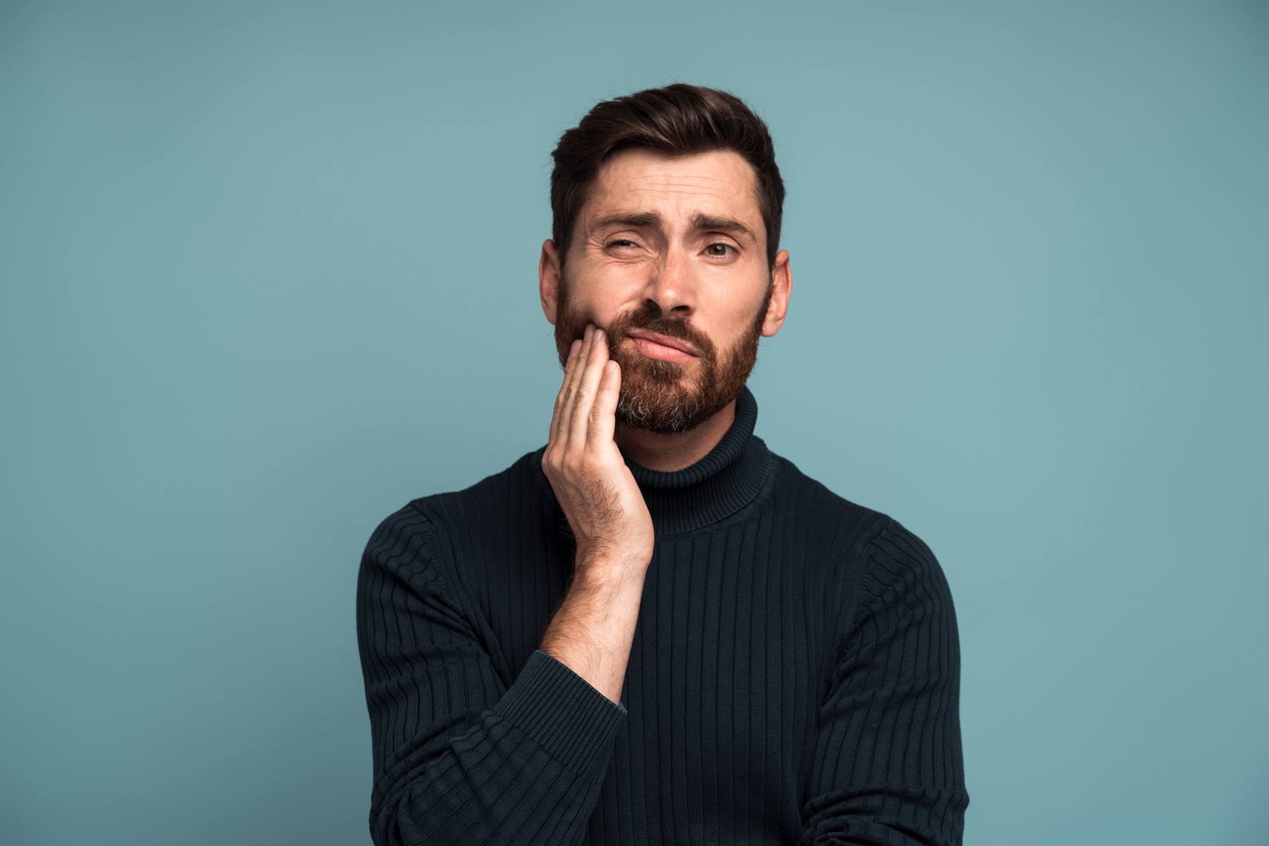 man holding tooth in pain 