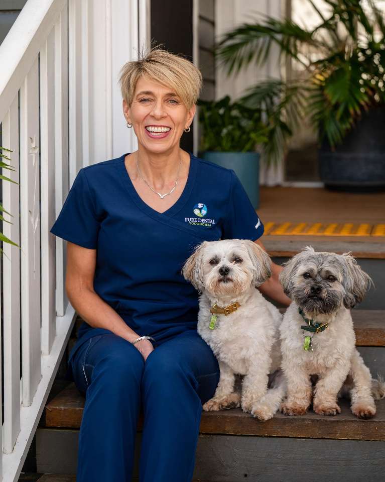 dr nicola dentist at pure dental sitting on step | general dentist toowoomba