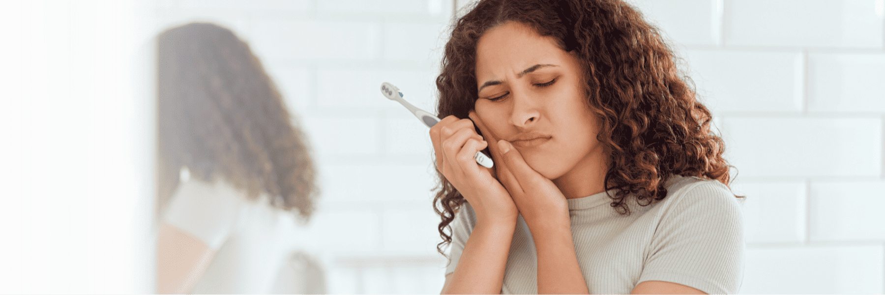 woman holding toothbrush | dentists toowoomba